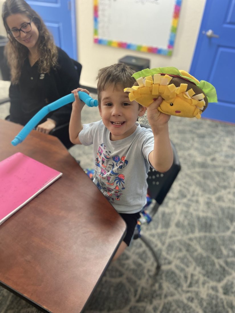 A child engaged in an ABA therapy session